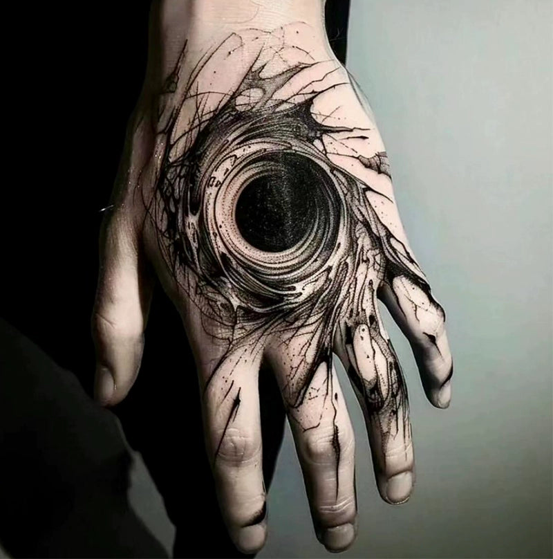 Black hole tattoo on the back of hand
